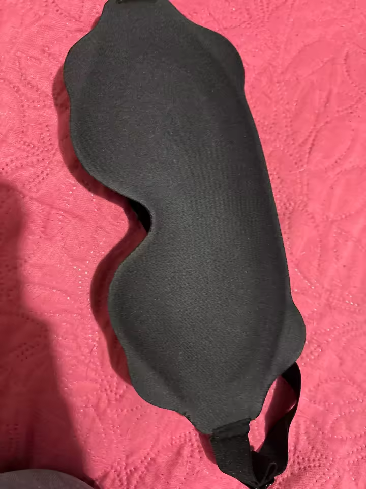Customer photo of the black eye mask on a pink bedspread