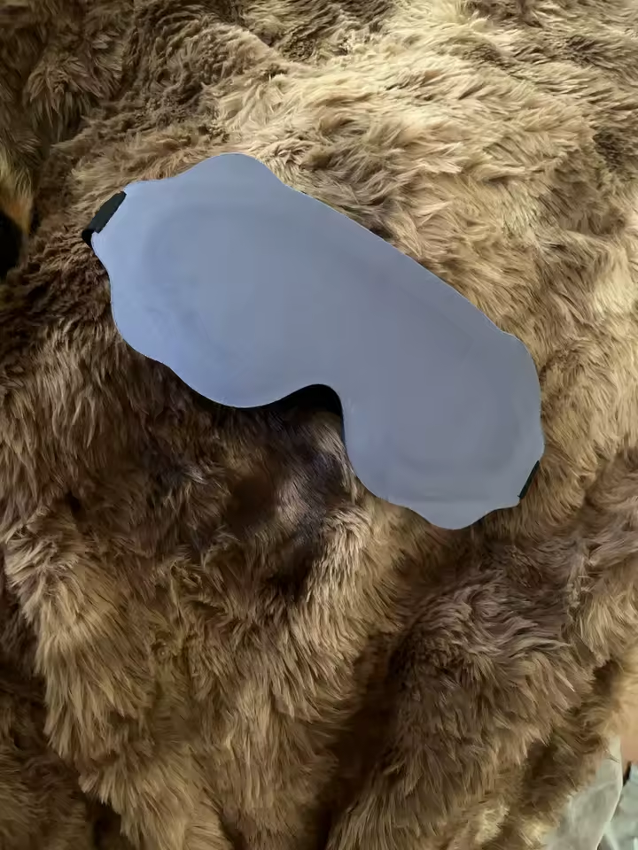 Customer photo of the purple eye mask resting on a soft blanket